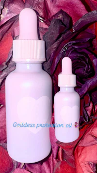 a bottle of griddless protection oil on a bed of roses