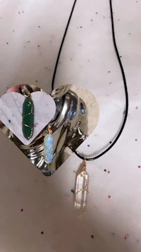 a heart shaped necklace with a heart shaped stone on it