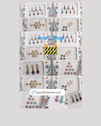 a set of earrings with different colored stones on them